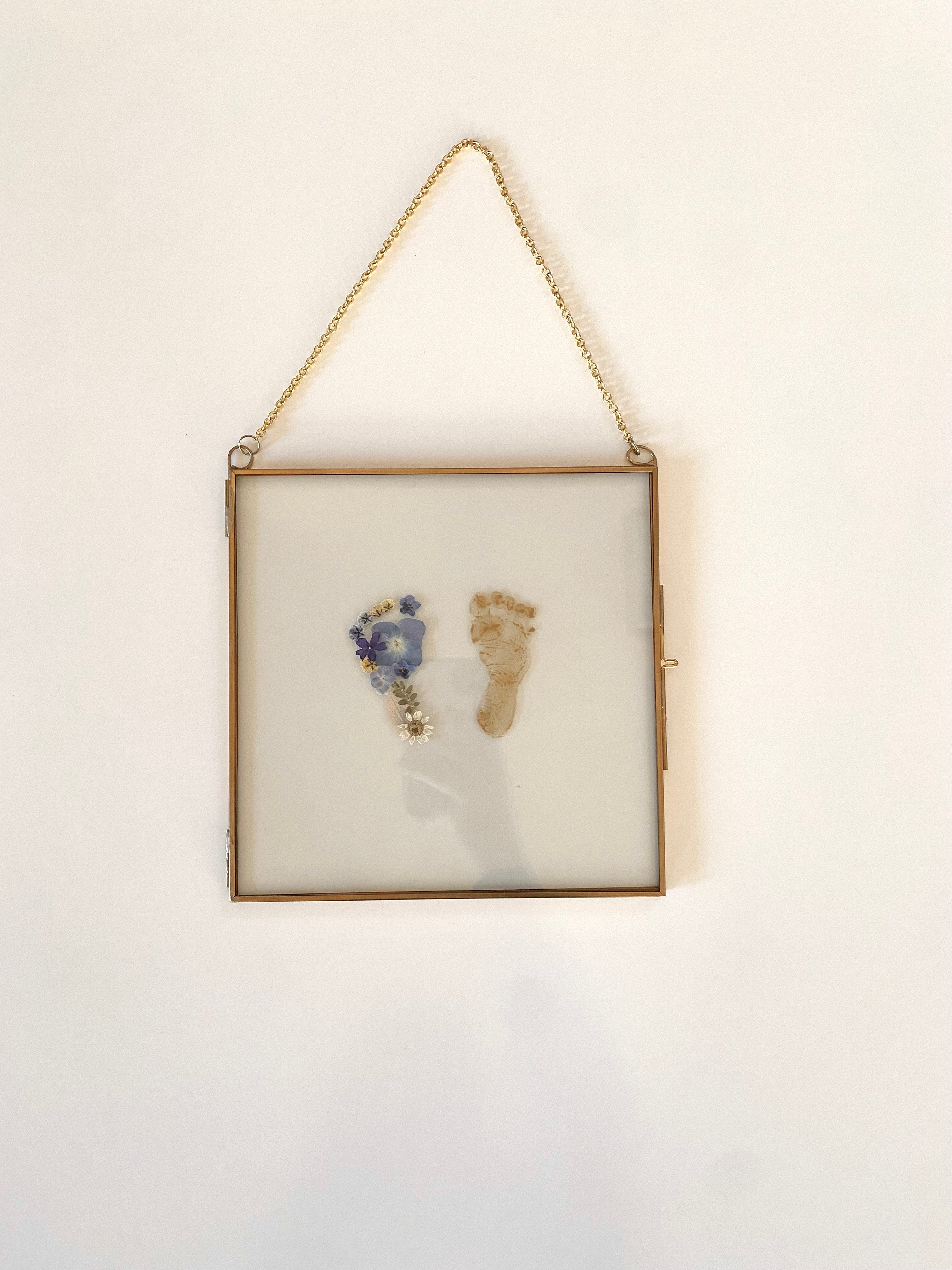 Close up of a floral baby footprint frame