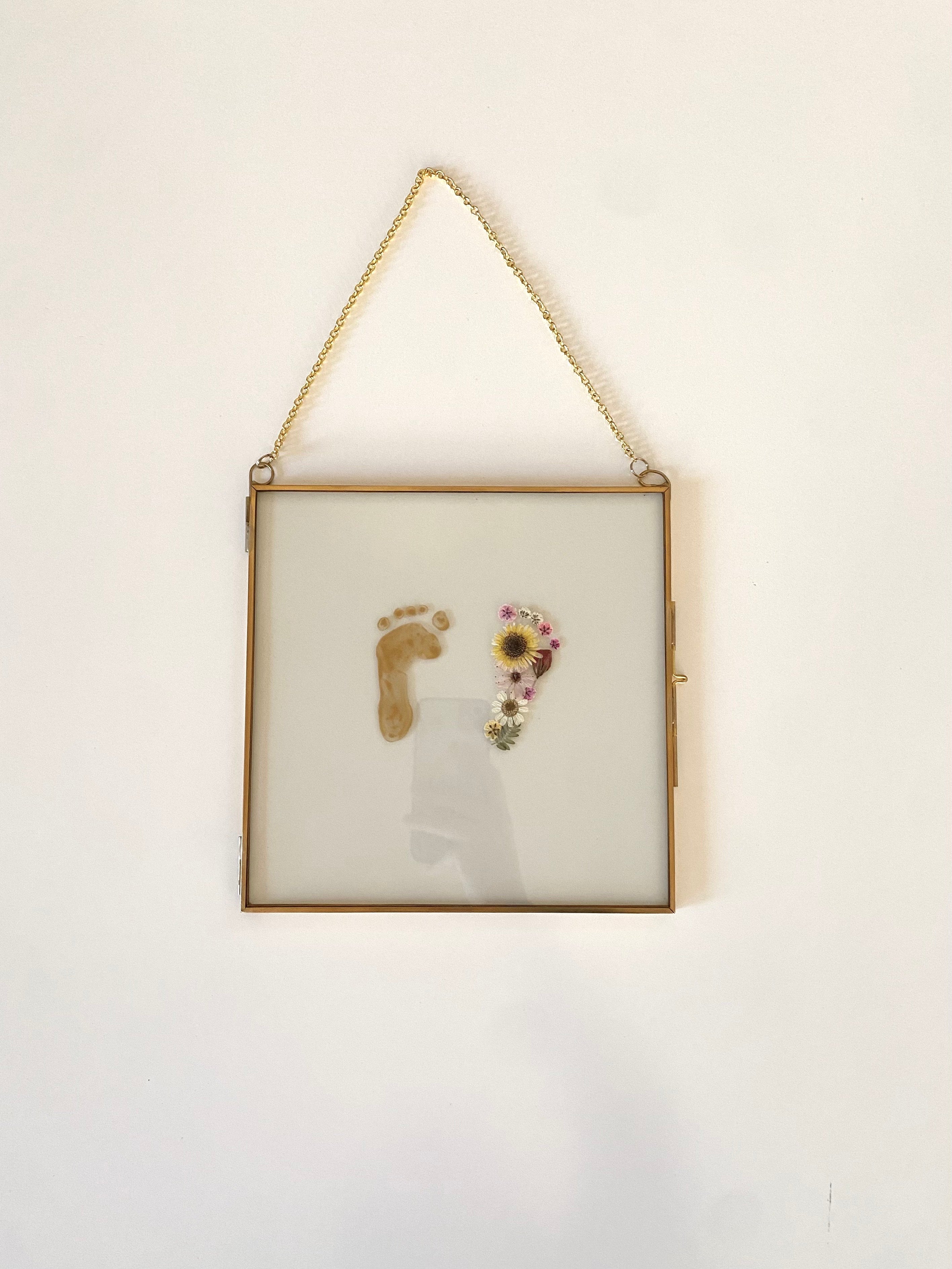 Baby footprint keepsake made with pressed petals